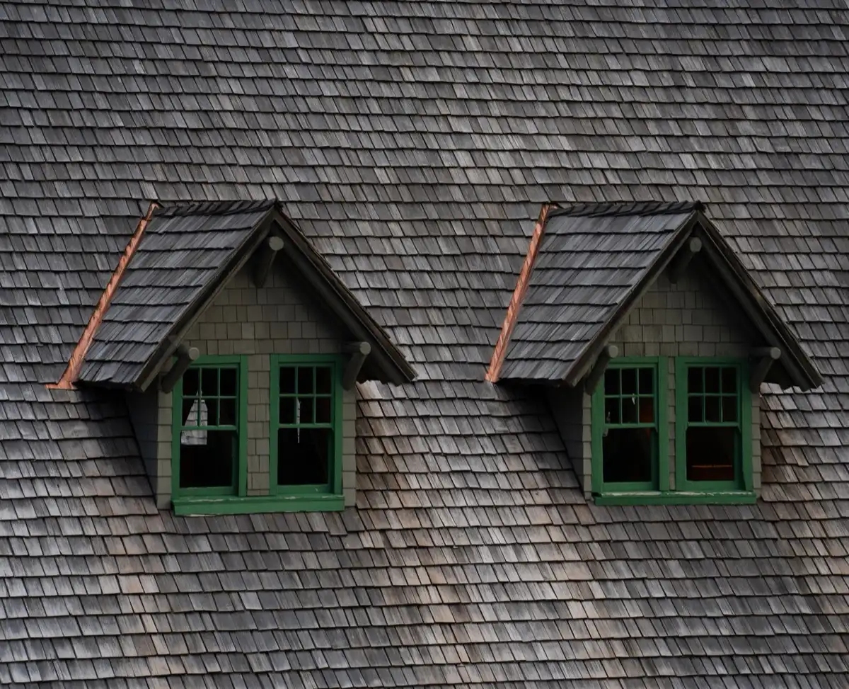 Dormers on a shingle roof in Abilene, TX, where step flashing and kickout flashing carry water past the walls